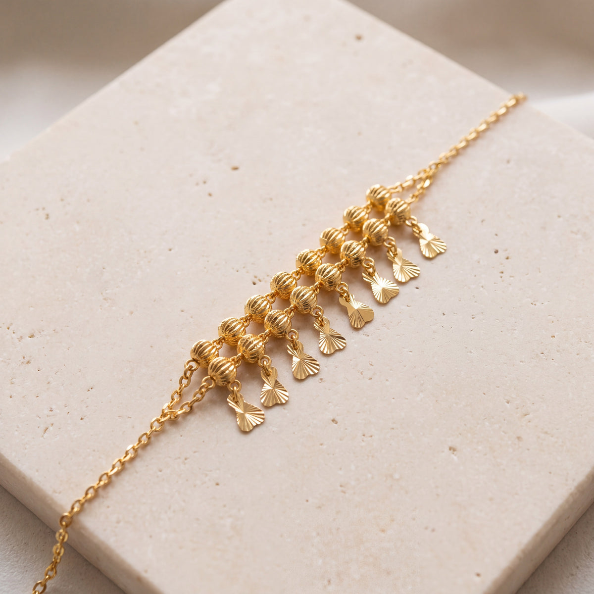 Twin Orb Fringe Bracelet (D8) on travertine